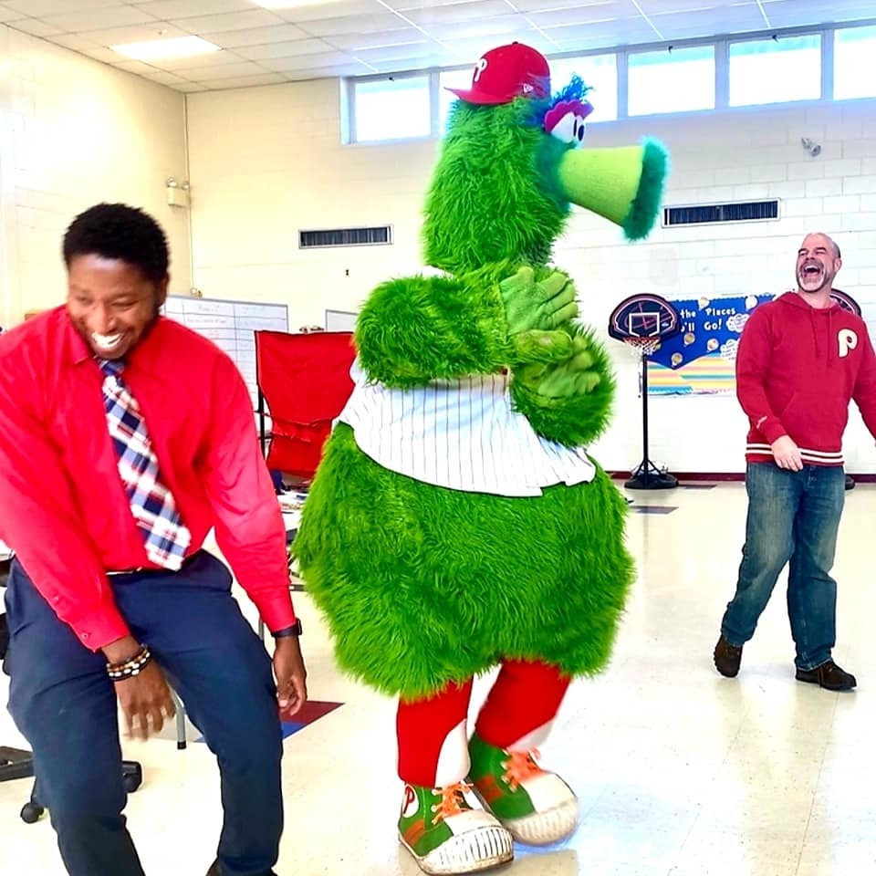 Phillie Phanatic dances with Mr. Farmer and Dr. Conway